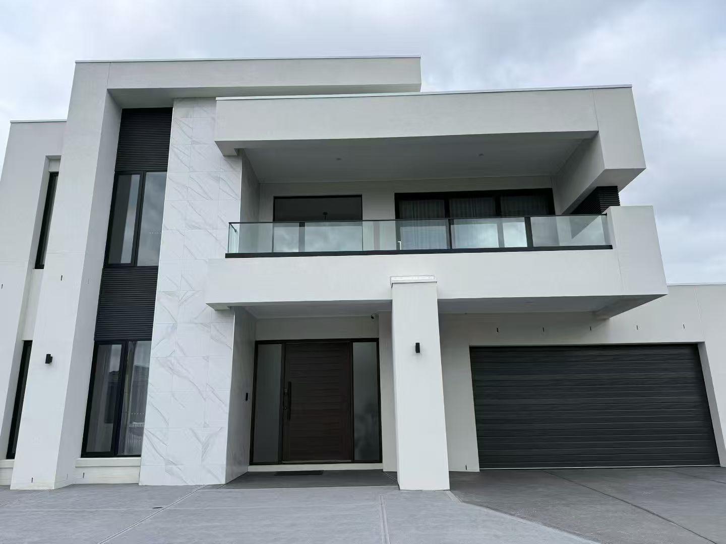 Modern two-storey home with black aluminium windows and doors by JL Windows